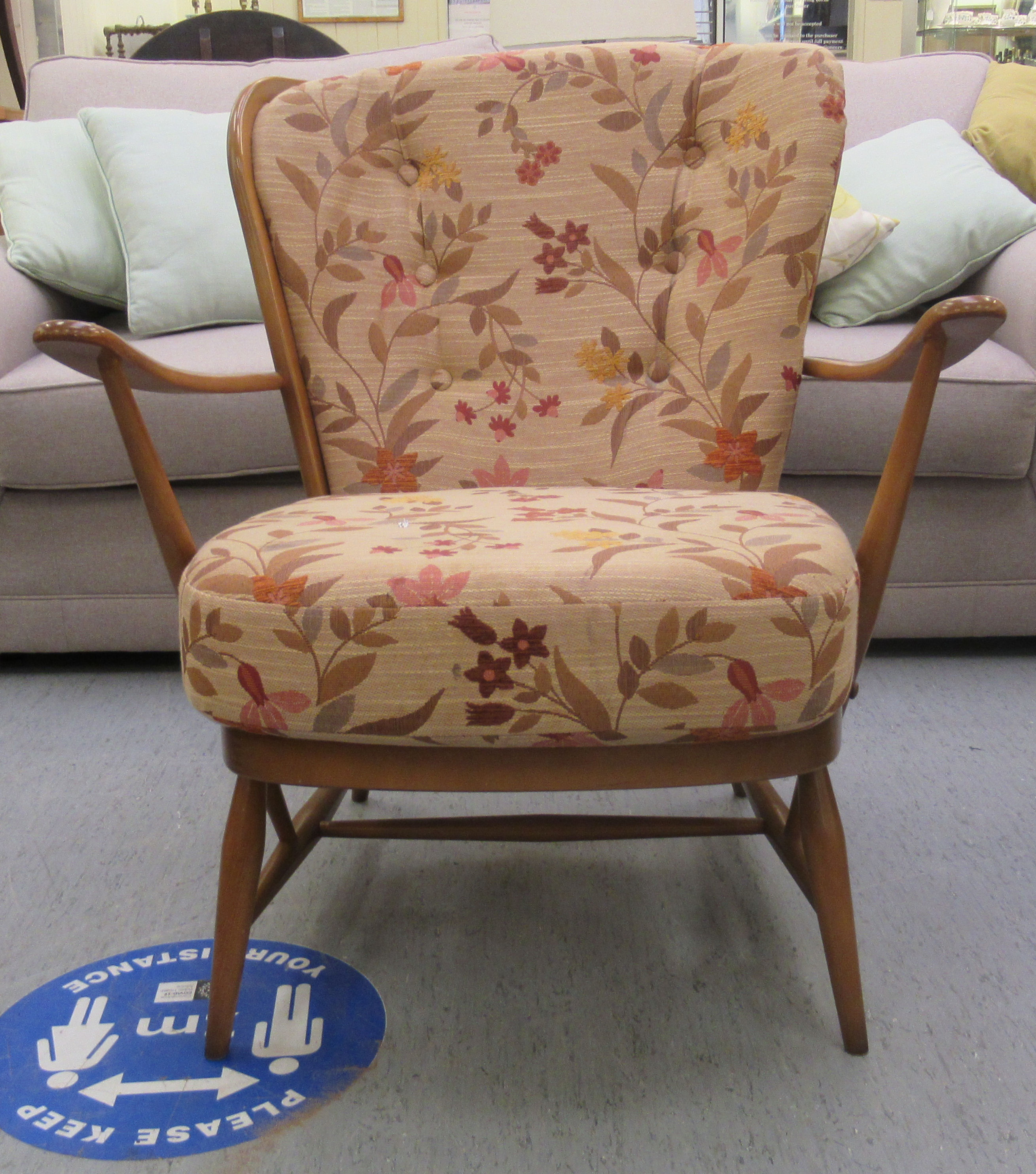 An Ercol Dawn beech and elm framed, low spindled back,