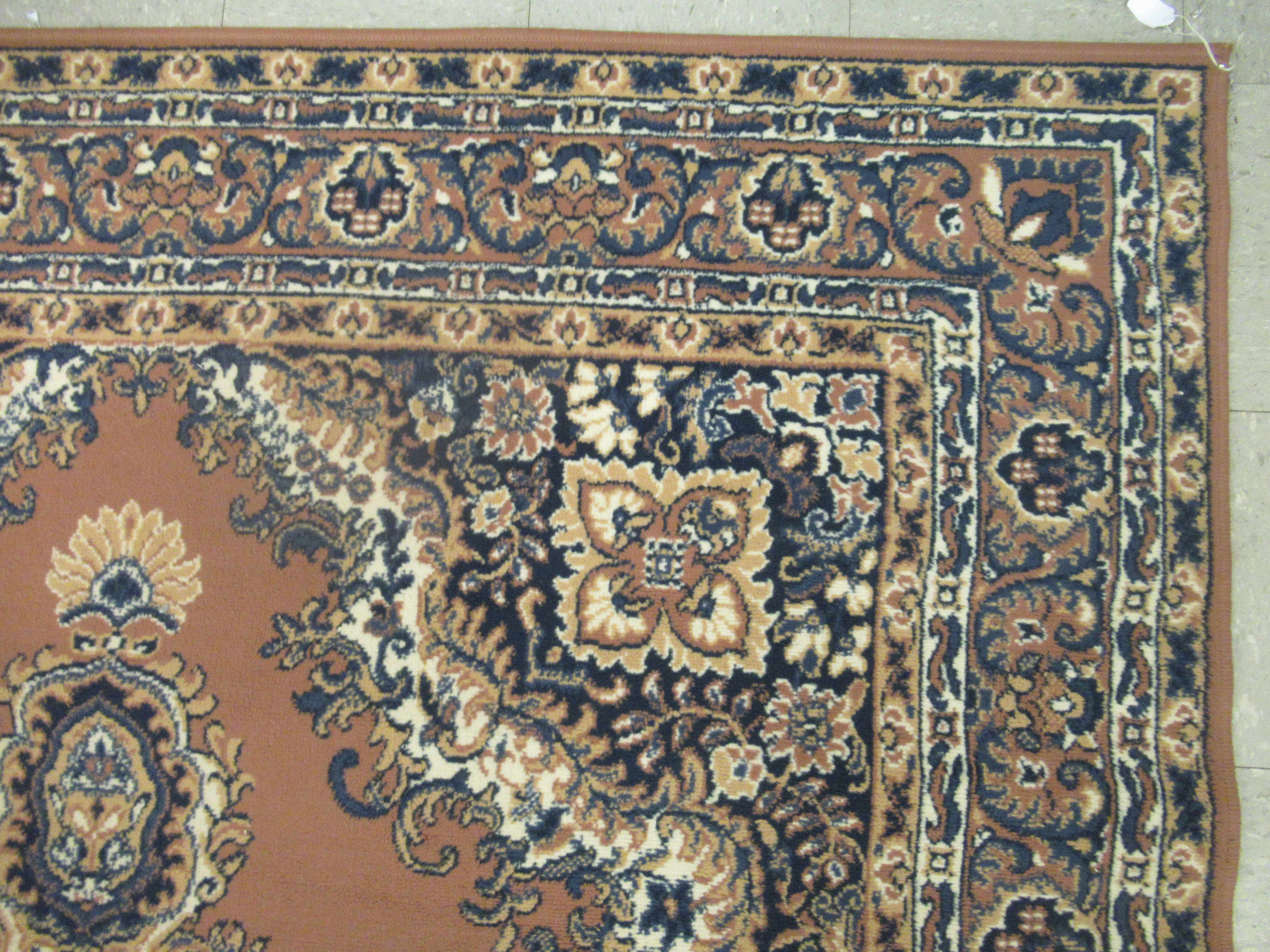 A machine made woollen rug, decorated with repeating squares of floral ornament, - Image 2 of 4