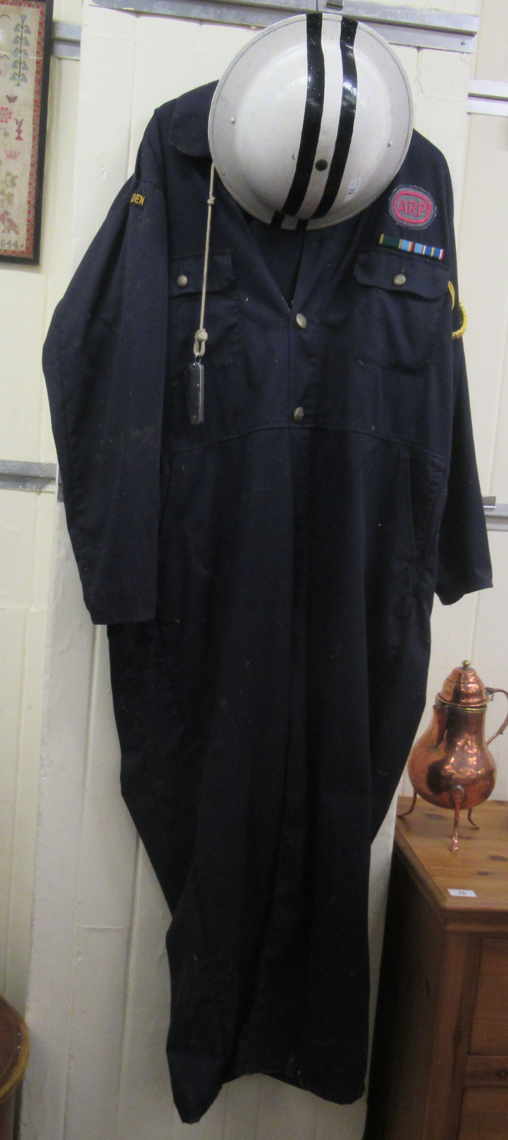 A World War II and later painted warden's helmet and ARP overalls (Please Note: this lot is