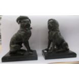 A pair of cast and patinated bronze models, seated French bulldogs, dressed as Punch & Judy, on