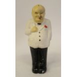 A painted plaster figure, Sir Winston Churchill, standing in typical pose, wearing a white jacket,