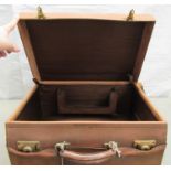 An early 20thC moulded and stitched pigskin vanity case with lacquered brass fittings and a