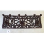 A modern cast iron wall mounted, triple hook coat rail  17"w