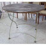 A slatted teak terrace table, raised on a folding, painted cast iron crossover underframe  30"h