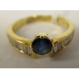 An 18ct gold single stone sapphire and diamond ring