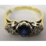 An 18ct gold three stone, claw set sapphire and diamond ring