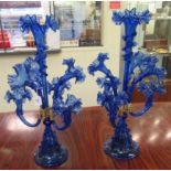 A pair of Victorian style Royal blue glass epergnes, each comprising seven frilled trumpets, on a