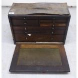 An early 20thC 'Neslein' oak tool chest with a removeable front panel, enclosing an arrangement of