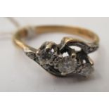 An 18ct gold three stone, crossover set diamond ring