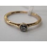 An 18ct gold single diamond set ring