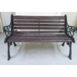 A Victorian style slatted teak bench with C-scrolled cast iron supports  50"w