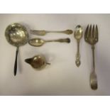 Silver tableware: to include an engraved fiddle pattern serving fork and a squat, bulbous cream jug