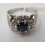 An 18ct bark effect, white gold sapphire and diamond set cluster ring