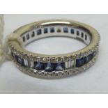 An 18ct white gold eternity ring, set with alternating sapphires and diamonds