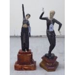 Two Art Deco inspired resin and bronzed finished figures, dancers in period costume, on stepped