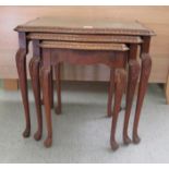 A nesting set of three mid 20thC Waring & Gillows walnut finished occasional tables, each with a