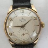 A mid 20thC 9ct gold cased wristwatch, faced by an Arabic and baton dial with subsidiary seconds, on