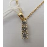 An 18ct gold fine neckchain with a diamond set pendant, on a ring bolt clasp