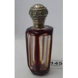 A Victorian style facet cut glass scent bottle with a silver coloured metal collar and cap