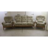 A Cintique of London, England, teak showwood framed three piece suite with floral patterned fabric
