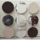 A mirror made from nine circular panels, the four corners being suede  27" x 27"