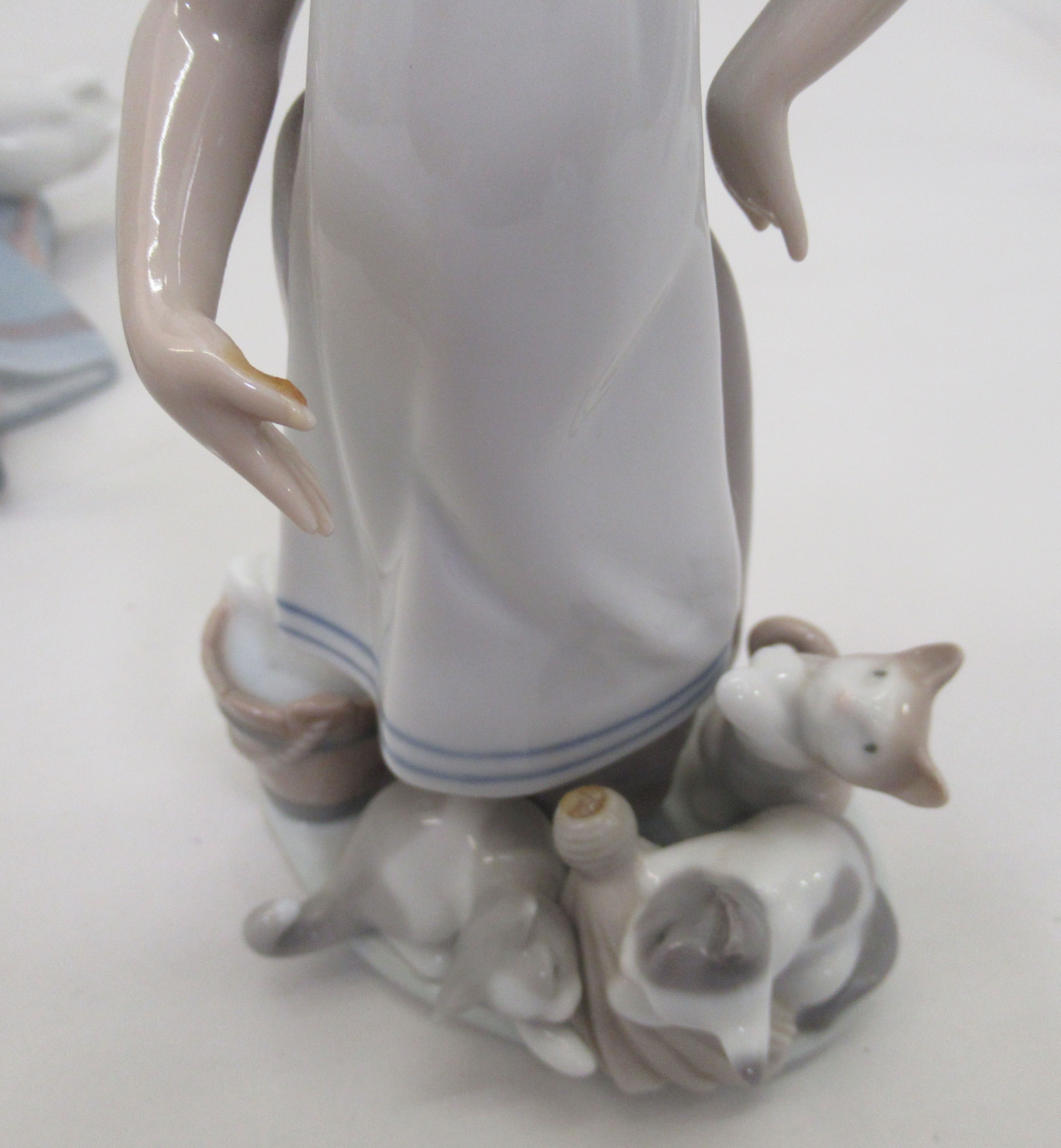 Seven Lladro porcelain figures: to include a young woman, carrying a lamb  11"h - Image 4 of 5