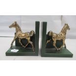 A pair of modern green hide covered bookends, surmounted by trotting brass horses  7"h  6.75"w