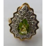 A 14ct gold claw set, pear shaped peridot and diamond cluster ring