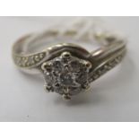 A 9ct white gold, crossover set diamond cluster ring