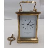 A Matthew Norman of London lacquered brass cased carriage timepiece with bevelled glass panels and a