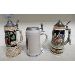 Three Bavarian china lidded tankards, two with musical features