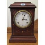 An Edwardian satinwood inlaid mahogany mantel clock; the 8 day movement faced by an enamelled Arabic