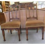 A pair of Art Nouveau period ebony and string inlaid, oak framed chairs, the fabric covered seats