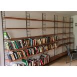 A 1970s String of Sweden, five section, pine shelving unit, on black painted metal wall brackets