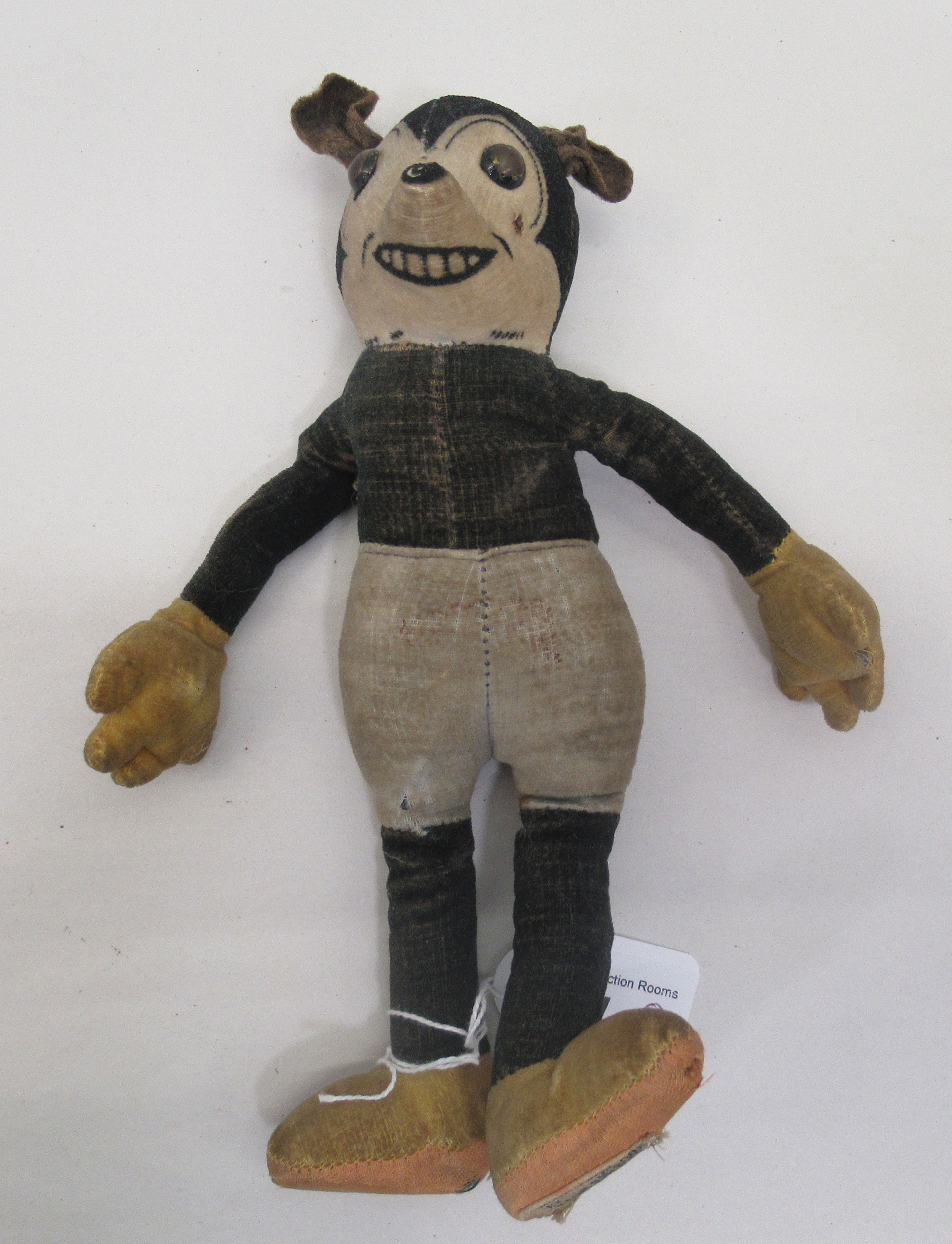 A circa 1930s stuffed, stitched, fabric toy 'Mickey Mouse' with mobile limbs  bears a label Deans