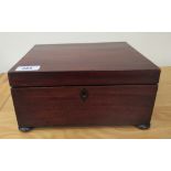 A late Victorian mahogany needlework box, having straight sides and a lockable, hinged lid, on bun