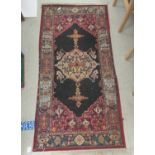 A Persian design rug, decorated with stylised ornament  30" x 62"