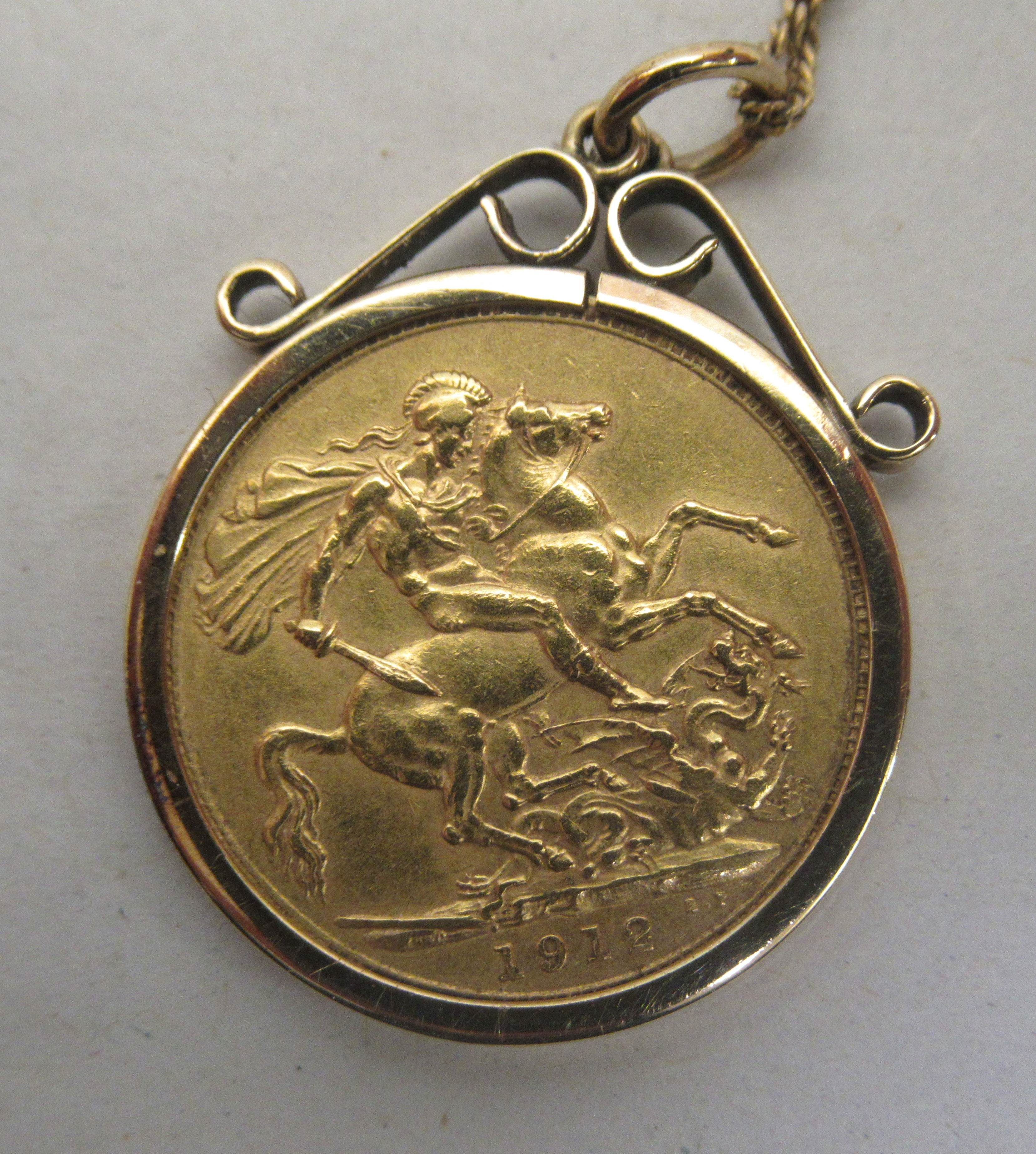 A George V sovereign, St George on the obverse  1912, in a 9ct gold mount, on a fine neckchain