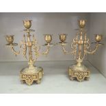 A pair of late Victorian gilt metal mantel sidepieces, each comprising three candle sockets,