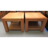 A pair of modern light oak coffee tables, raised on square legs  19"h  23"sq