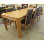 A modern Continental light oak dining table with round corners, raised on straight legs  31"h  63"L