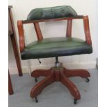 A modern stained beech office swivel chair, upholstered in green hide, raised on casters