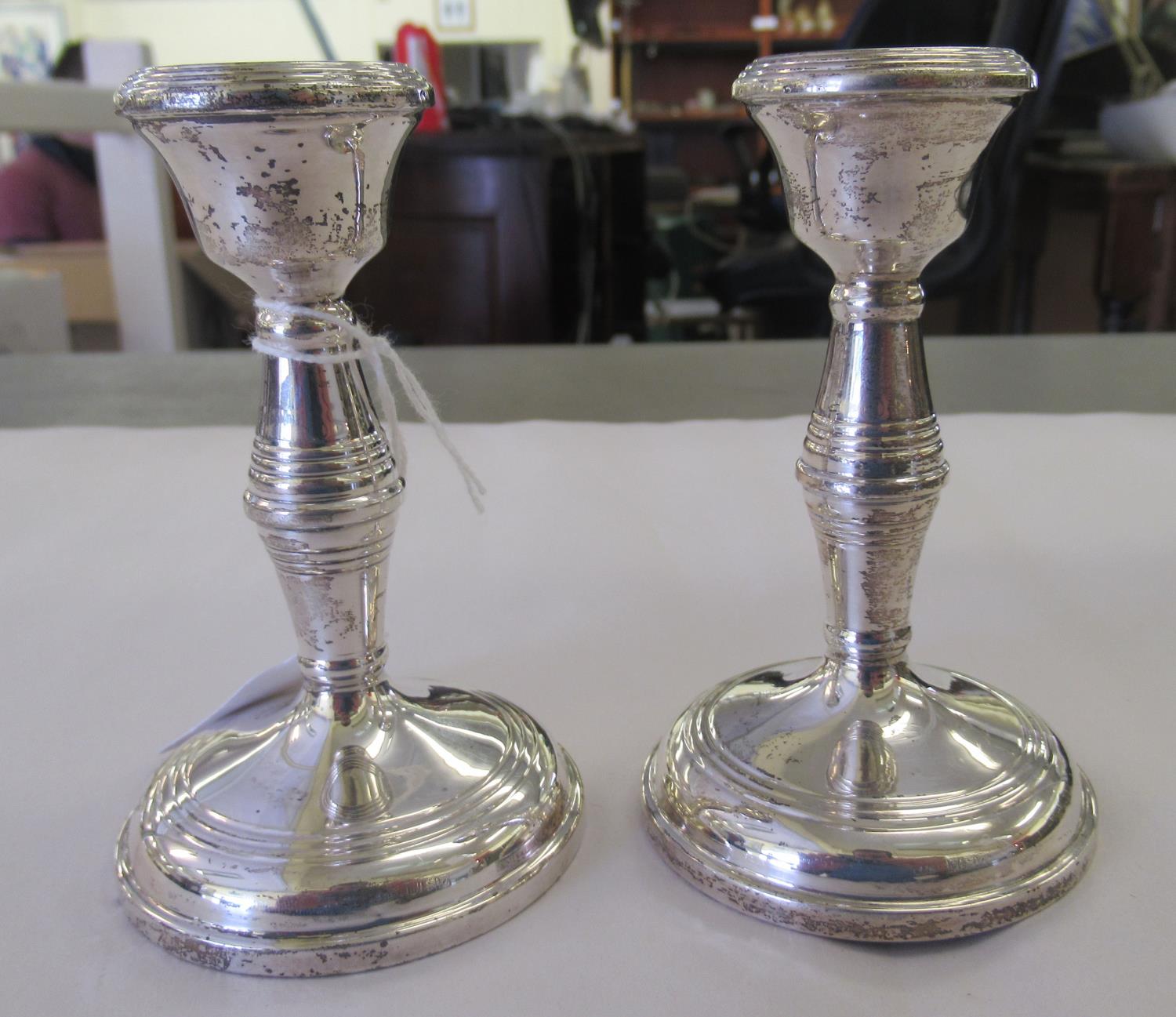 A pair of loaded silver candlesticks with integral sockets and baluster stems  Birmingham 1963  4. - Image 2 of 3