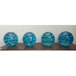 A set of four light blue coloured glass paperweights with bubble ornament  5"h
