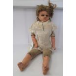 A 19thC wax head doll with fabric body and ceramic lower limbs  15"h