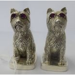A pair of silver plated novelty condiments pots, fashioned as seated dogs with ruby eyes