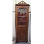 An Edwardian satinwood inlaid mahogany corner cabinet, having a double swan neck pediment, over a