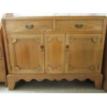 An early 20thC and later light oak sideboard with two inline drawers, over a pair of panelled doors,