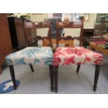 A pair of Regency mahogany dining chairs with curved bar crests and carved horizontal splats, the