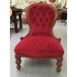 A late Victorian mahogany showwood framed salon chair, the part button, red fabric covered back